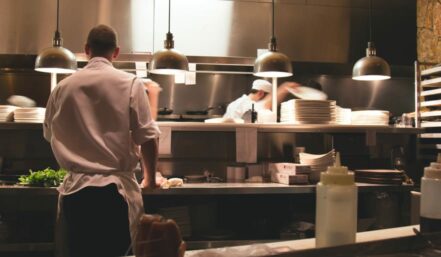 chefs cooking in a kitchen.