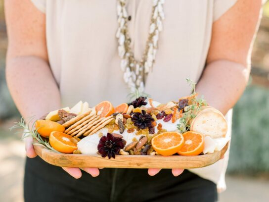 server holding a tray of food at a wedding.