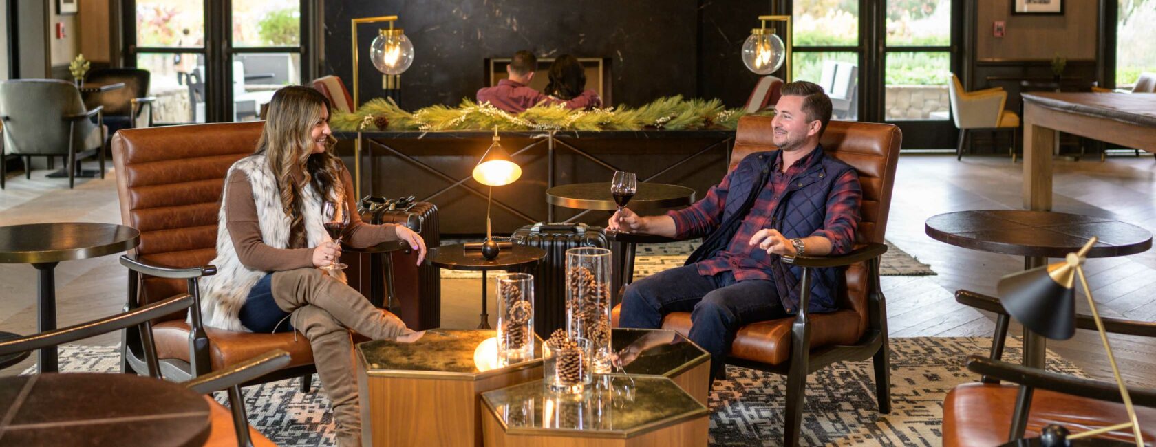 couple in a lobby with wine.