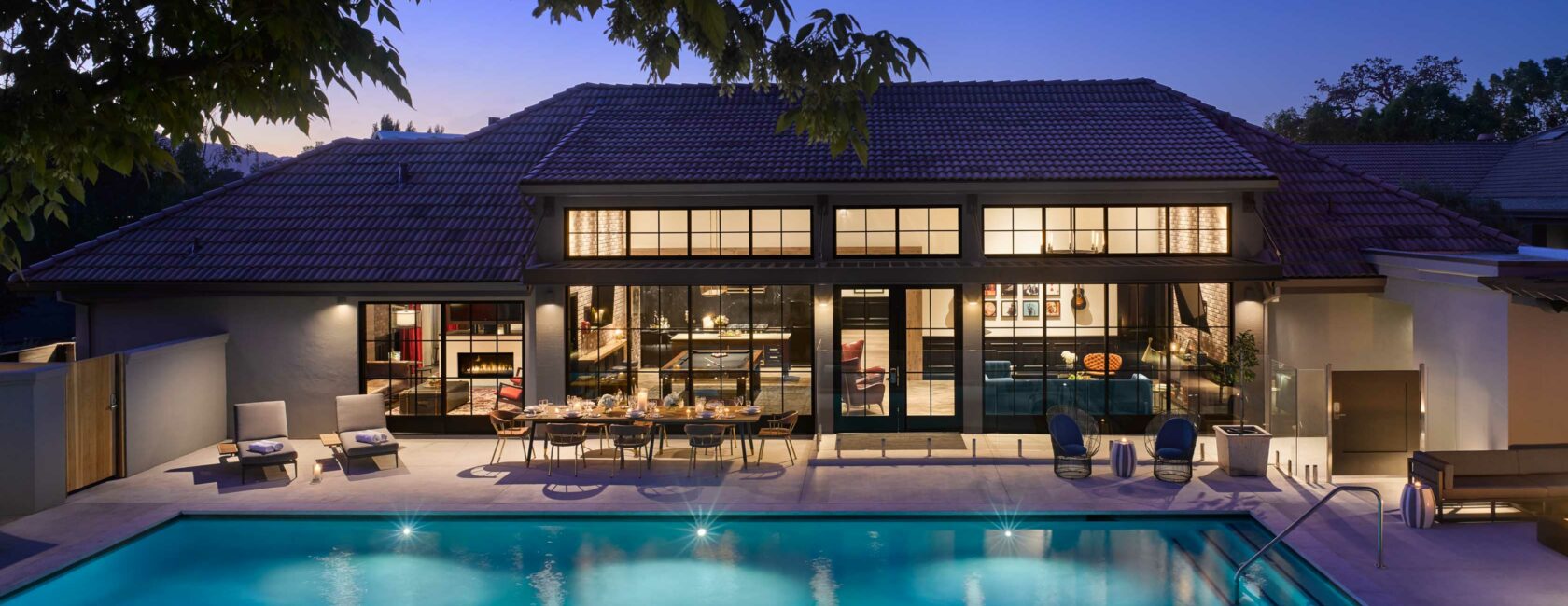 exterior of the villa and pool at night.